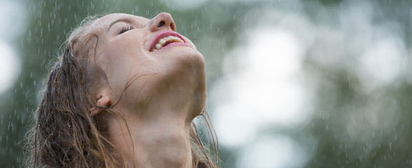 Young woman enjoying rain