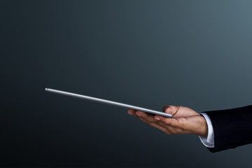 Part of Businessman Hand holding a digital tablet for present modern business work, Side view, Dark tone