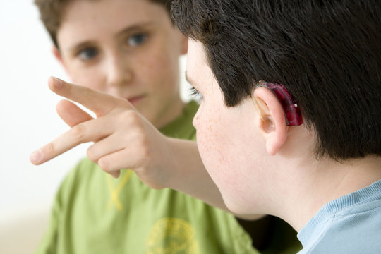 Models Do not use for HIV A young boy and his brother using the French sign language to discuss with his hearing-impaired brother The French sign language uses signs to designate words but also dactylology (each letter of the alphabet is represented by a defined position of the fingers then enabling to spell a word) and the lip reading The young boy designates the letter \k\ (see image nﾰ0833202 and series of images from nﾰ0572308 to 0573508 to see the other letters of the alphabet)