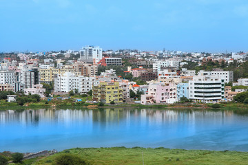 Fototapeta na wymiar Residential buildings by the lake in an Indian cityscape