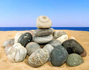 stones on the sand against the sky