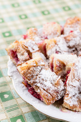 Cherry cake with powdered sugar on the plate