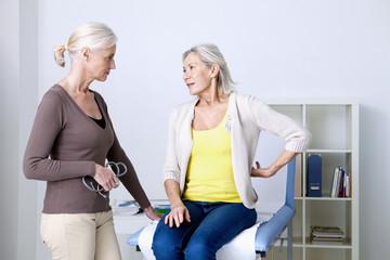 Female patient consulting for lumbar pain