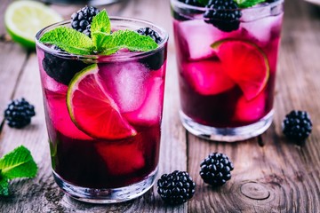 Blackberry smash  cocktail  with lime, and mint