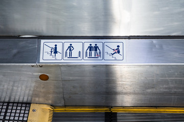 signs on an escalator, warning signs, the escalator
