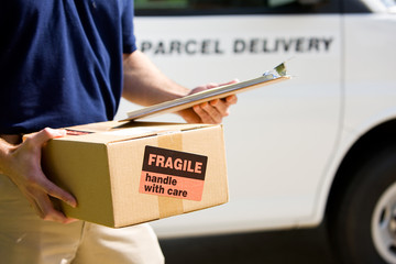 Delivery: Focus on Cardboard Box with Label