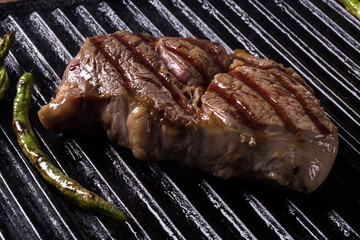 Ancho steak with grilled vegetables on the grill