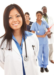 Fototapeta premium Doctors: Physician in Lab Coat with Others Behind