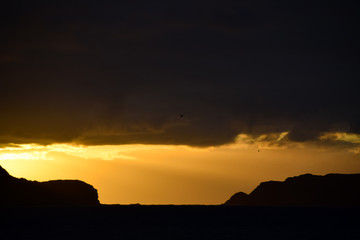  Sunrise over headland and the Atlantic Ocean from the beach at Porto Santo Island, Madeira, Portugal
