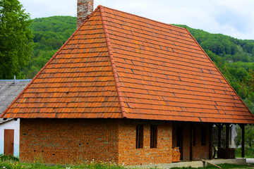 Fototapeta na wymiar Unfinished house with a tiled roof in the village