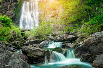Fototapeta na wymiar Khlong Lan Waterfall, beautiful waterfall in tropical forest, Kamphaeng Phet province, Thailand