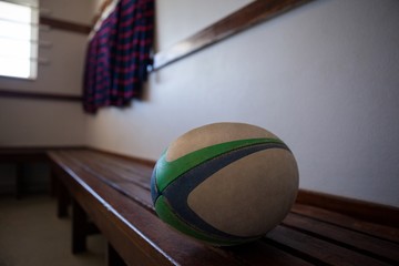 Close-up of rugby ball on bench - obrazy, fototapety, plakaty