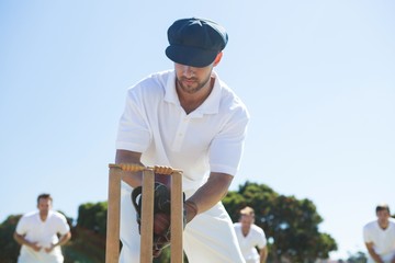 Close up of wicket keeper standing by stumps
