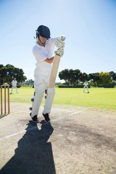 Full length of batsman standing on pitch