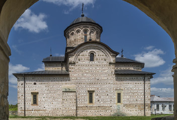 Fototapeta na wymiar The Princely Church of Saint Nicholas, Curtea de Arges, Romania, framed in an arch