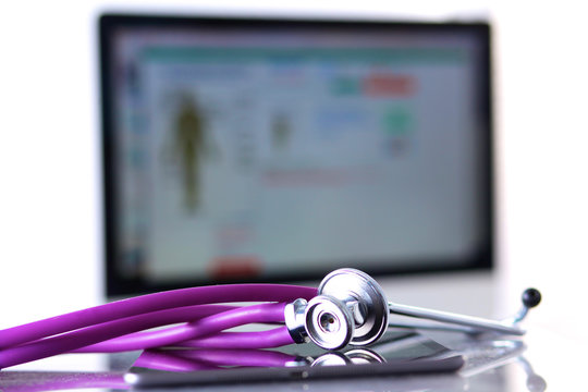 Stethoscope with a tablet computer lie on a table