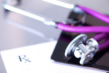 Stethoscope with a tablet computer lie on a table