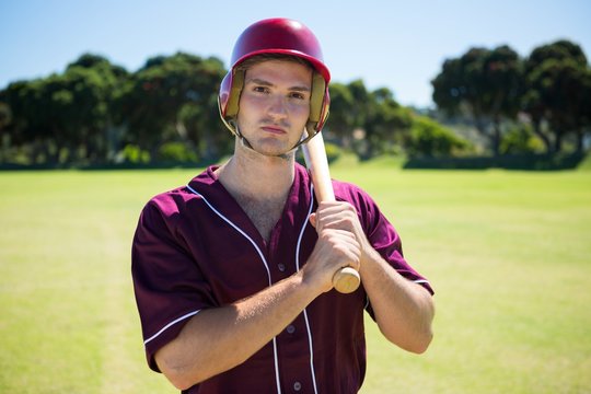 Portrait of young baseball player holding bat