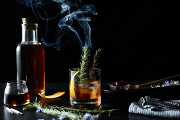 Maple old fashion cocktail drink with smoking rosemary