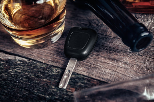Car key and whisky on bar table