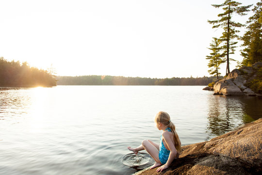 Little Girl Swimming at Lake with Summer Sunset