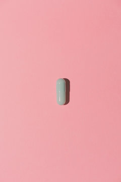 Pill on pink background from above