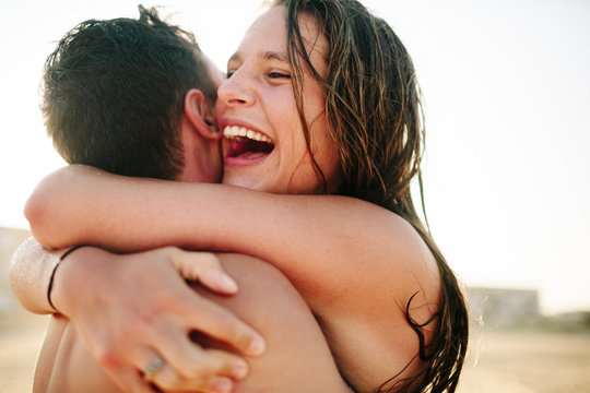 Boyfriend and girlfriend lovingly embrace each other 