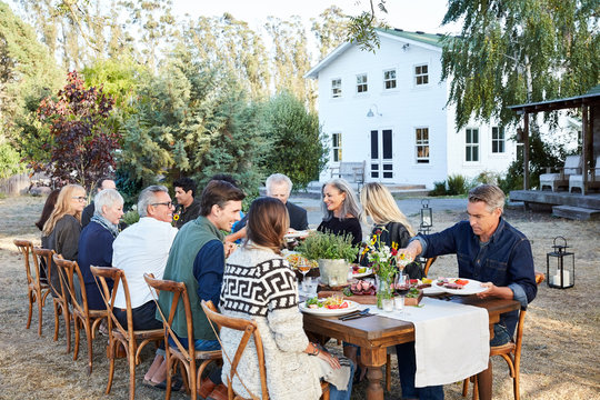 Group Of Friends Enjoying A Farm To Table Dinner Party