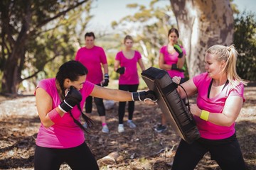Woman practicing boxing in the boot camp