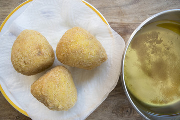 arancine fried in boiling oil