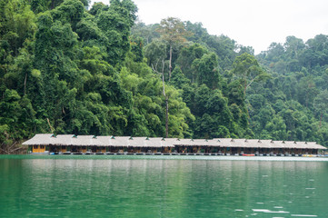 Fototapeta na wymiar Floating bungalows set against the backdrop of luxuriant jungle