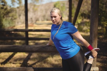Portrait of woman exercising during obstacle course