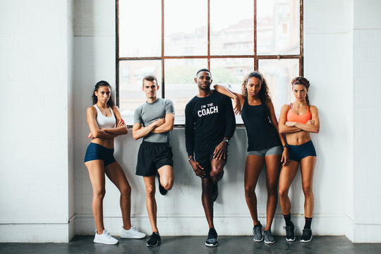 Portrait of multiethnic group of athletes standing in the gym 