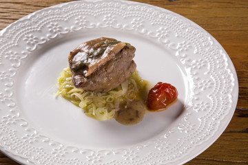 Saltimbocca veals in rich Neapolitan sauce and tagliatelle pasta