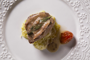 Saltimbocca veals in rich Neapolitan sauce and tagliatelle pasta