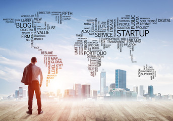 Motivation and inspiration concept with modern cityscape and businessman observing it