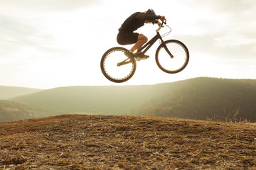 Fototapeta na wymiar Male biker in moment of jumping