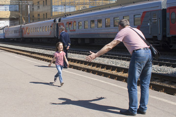 Naklejka premium Long-awaited joyful meeting on the platform of the railway station