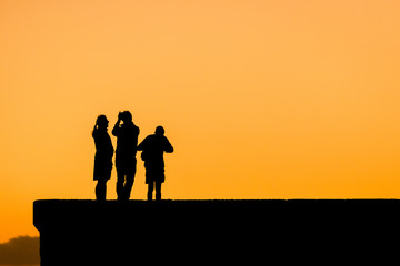 Tourists trying to catch the sundown. Near the Maspalomas Lighthouse in the south of Gran Canaria