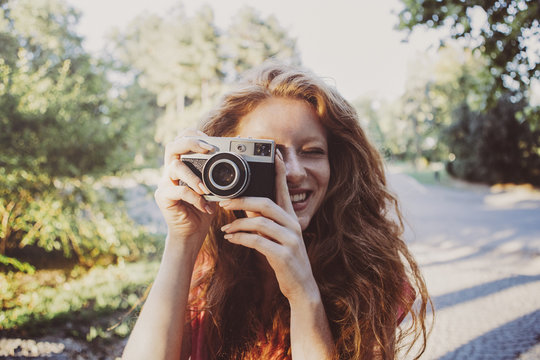 Smiling Ginger Woman Taking a Photo