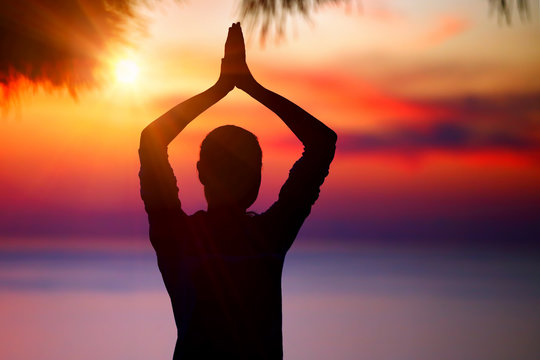Doing yoga on sunset