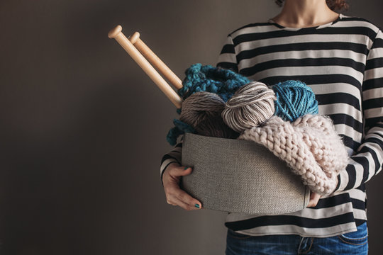 Woman Holding a Box Full of Yarn