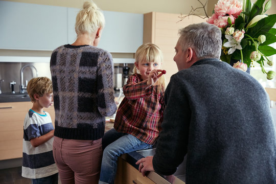 Family making breakfast together in the kitchen