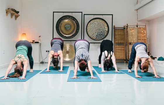 Five women practicing yoga