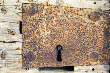 antique iron key hole on wooden door