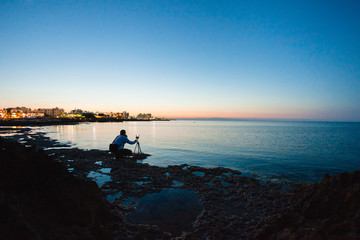 Photographer taking a photo of a sea view