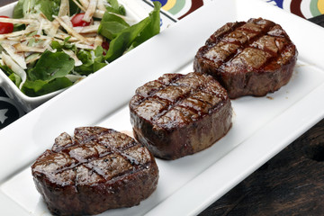 Three steaks roasted on the grill