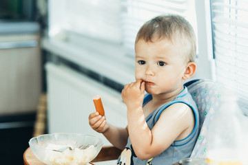 The child greedily eating the sausage