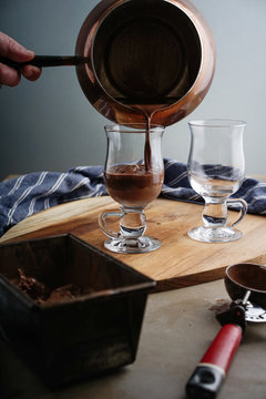 Hot chocolate drink being poured into a glass