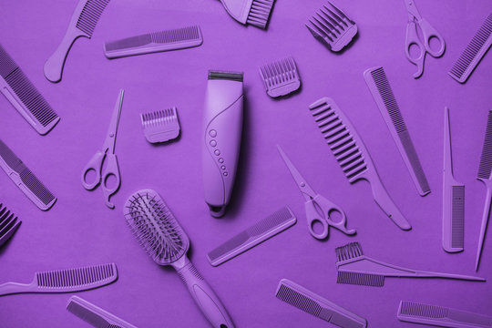 Various hairdresser tools in purple color on purple background